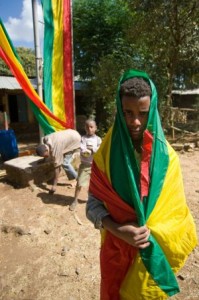 A boy in the Ethiopian Flag in Northern Ethiopia, Photo By Travis Horn